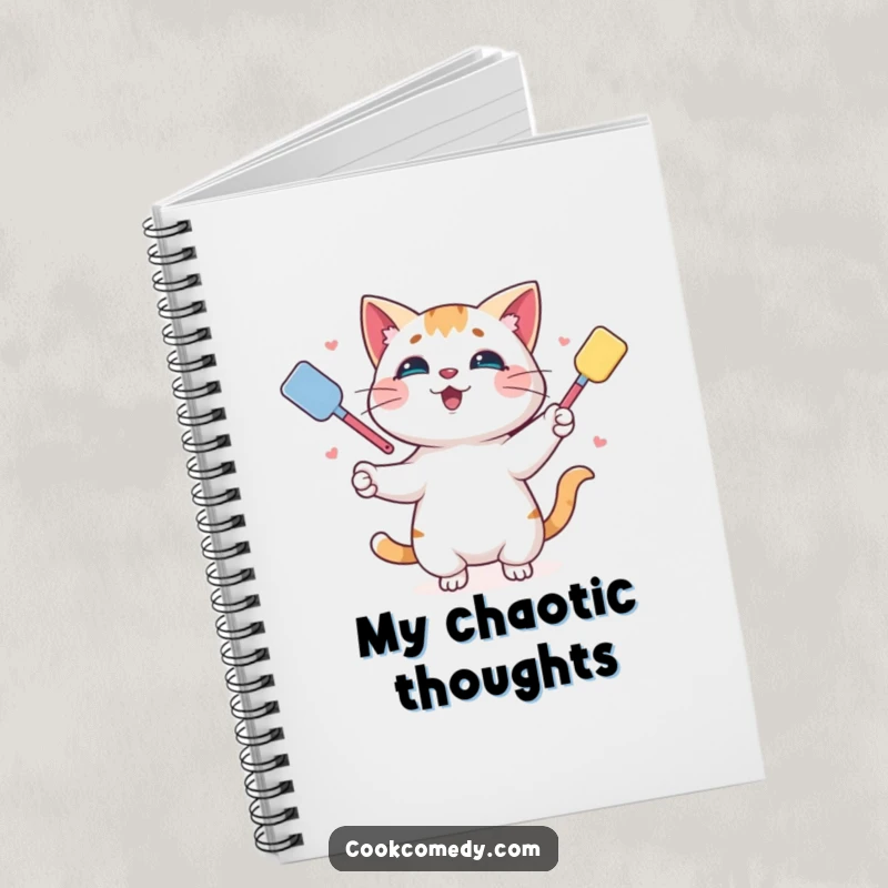 Funny notebook with a playful cat juggling spatulas, ideal for jotting down recipes and kitchen notes.