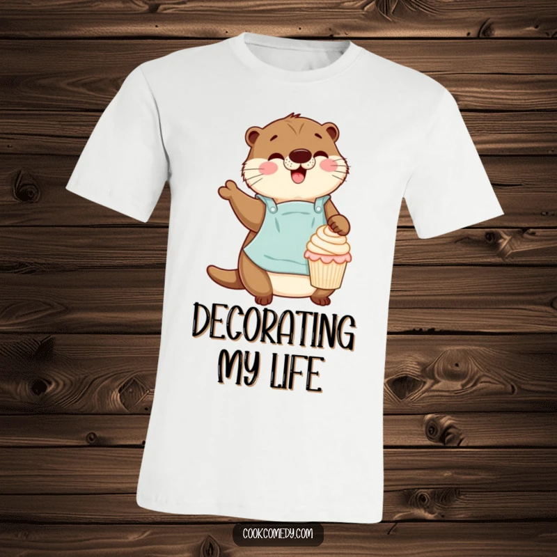 Funny otter in an apron gleefully decorating a tiny cupcake on a comfortable t-shirt, celebrating baking.